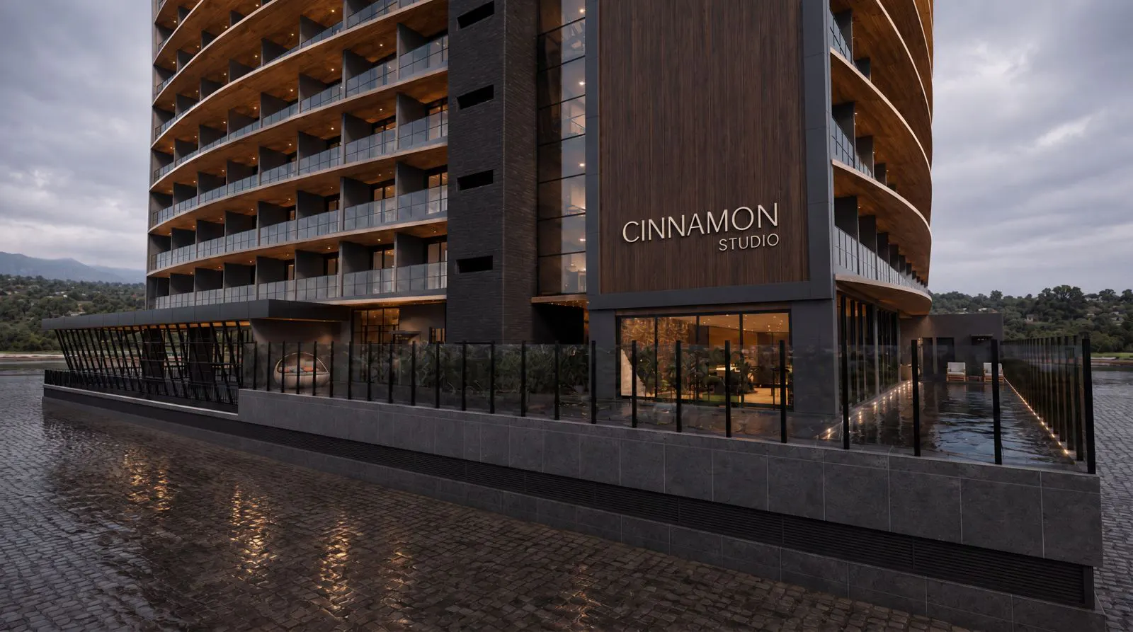 Térreo do Cinnamon Studio visto da rua, com a piscina de borda de vidro e o paisagismo junto à calçada.